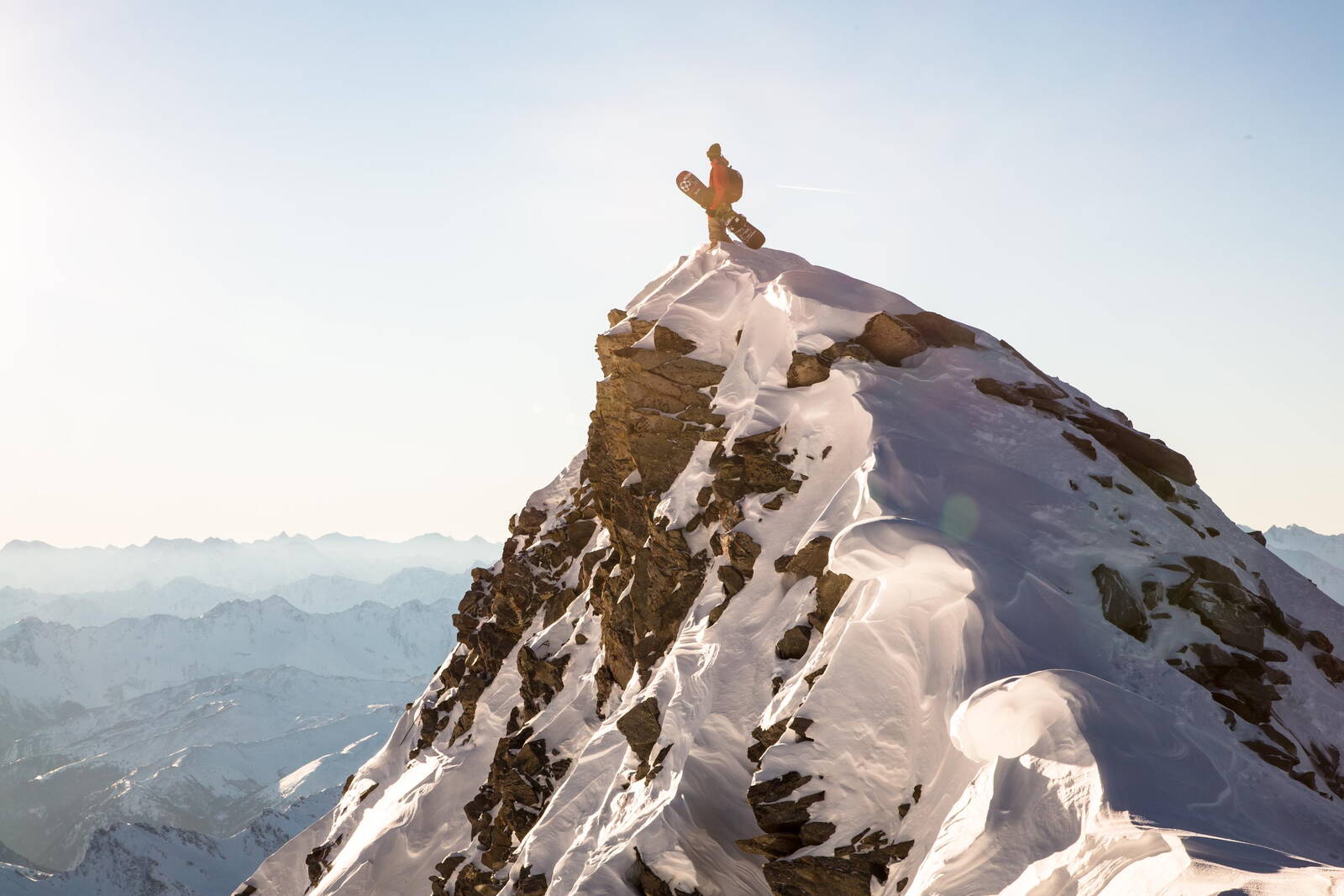 Snowboarder on mountain peak